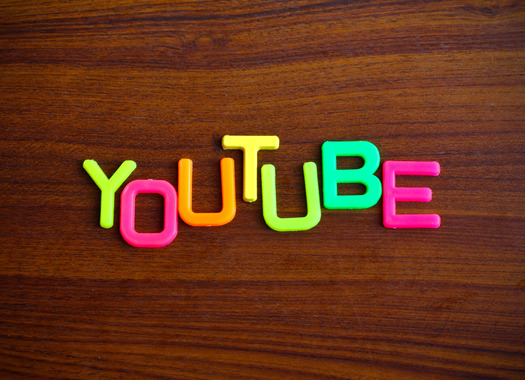 Youtube in colorful toy letters on wood background