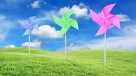 Paper toy windmill in green grass field