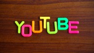 Youtube in colorful toy letters on wood background