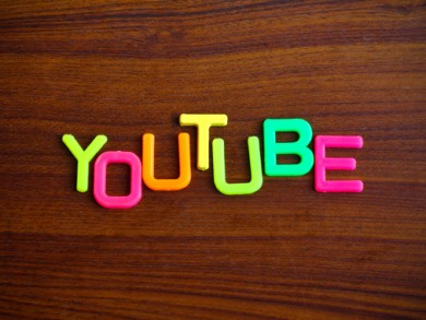 Youtube in colorful toy letters on wood background